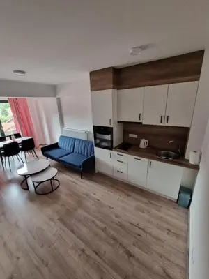 a living room with a blue couch and a table at Apartman Rita in Fojnica