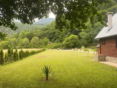 a large yard with a house and a field of grass at Holiday Home UnaPark in Krakovo