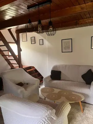 a living room with two couches and a table at Holiday Home UnaPark in Krakovo
