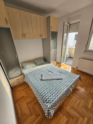 a small room with two beds in a room at Apartman City One in Banja Luka