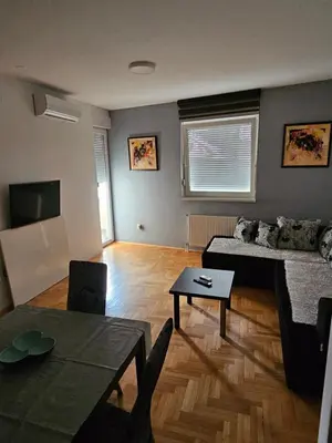 a living room with a couch and a table at Apartman City One in Banja Luka