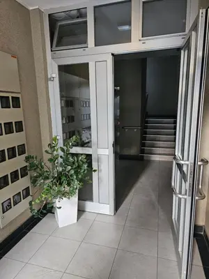 a hallway of a building with a potted plant at Apartman City One in Banja Luka