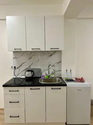 a kitchen with white cabinets and a sink at Jelena in Jajce