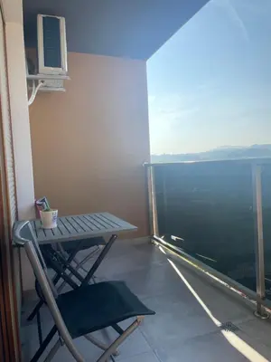 a table and a chair on a balcony with a view at Oaza 3 in Doboj