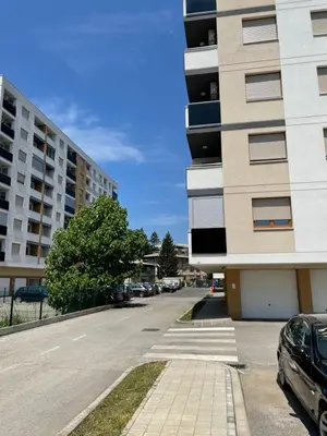 an empty street next to a tall building at Oaza 3 in Doboj