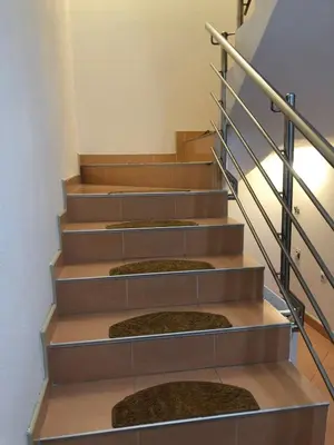 a set of stairs with metal railings at Ema's apartments in Bihać