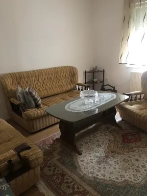 a living room with a couch and a coffee table at Ema's apartments in Bihać