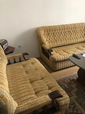a living room with two couches and a table at Ema's apartments in Bihać