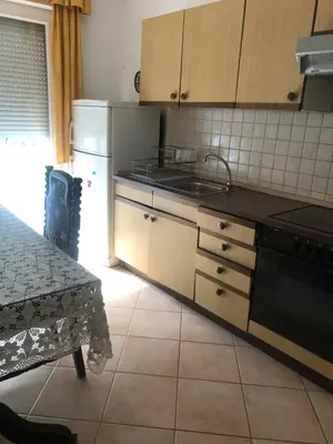 a kitchen with a sink and a stove at Ema's apartments in Bihać