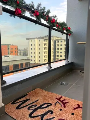 a window with christmas decorations and a rug at BL Soul Apartment in Banja Luka