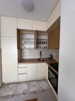 a kitchen with white cabinets and a sink at BL Soul Apartment in Banja Luka