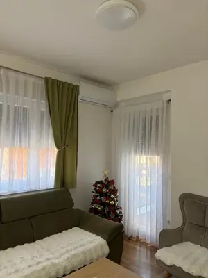 a living room with a christmas tree and a couch at BL Soul Apartment in Banja Luka