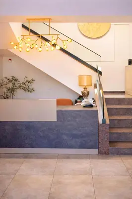 a stairwell with a blue and white wall and a staircase with a blue counter at Motel Marić in Žepče