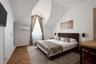 a bedroom with a large bed and a window at Motel Marić in Žepče