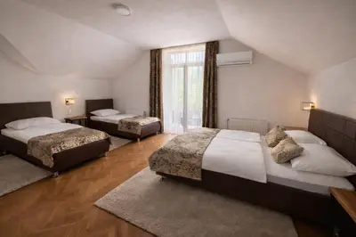 a bedroom with two beds and a window at Motel Marić in Žepče