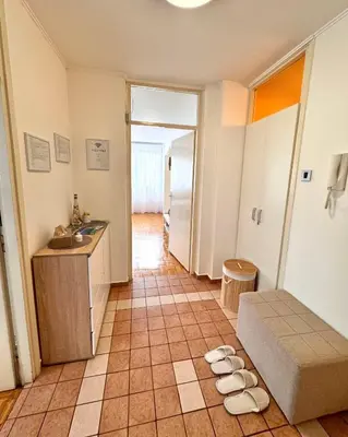 a room with a kitchen and a couch and a table at Apartman Tanja in Banja Luka