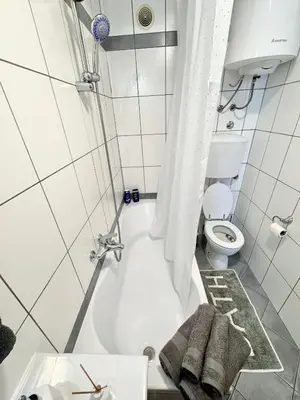 a bathroom with a tub and a toilet and a sink at Apartman Tanja in Banja Luka