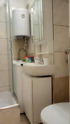 a bathroom with a sink and a toilet and a mirror at WUGE Bihac in Bihać