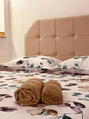 a bed with two towels on top of it at Studio apartman Ana in Livno