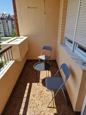 two chairs and a table on a balcony at Cozy in Zenica