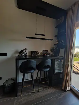 a kitchen with two bar stools and a table at Diamond Stan na Dan in Kiseljak