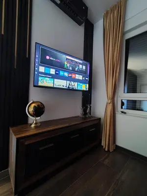 a living room with a flat screen tv on a wall at Diamond Stan na Dan in Kiseljak