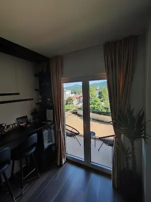 a kitchen with a sliding glass door with a view of a patio at Diamond Stan na Dan in Kiseljak
