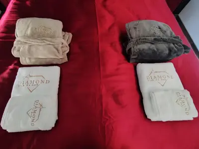 a couple of towels on a red blanket at Diamond Stan na Dan in Kiseljak