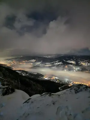 a view of a city at night in the snow at Cupcake Apartments in Šišava