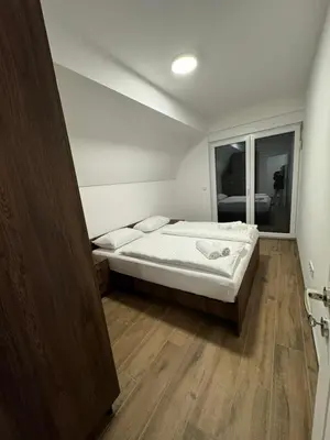 a small bedroom with a bed and a window at Cupcake Apartments in Šišava