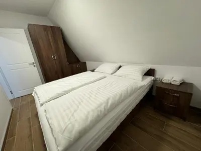 a bed with white sheets and pillows in a bedroom at Cupcake Apartments in Šišava
