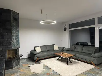 a living room with two couches and a fireplace at Cupcake Apartments in Šišava