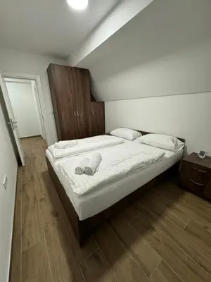 a bedroom with a large bed with white sheets and pillows at Cupcake Apartments in Šišava