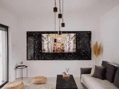 a living room with a couch and a painting on the wall at Villa Eden Bihać in Bihać