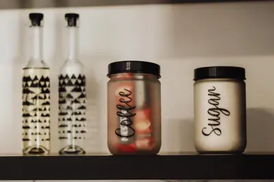a shelf with bottles and mason jars on it at Villa Eden Bihać in Bihać