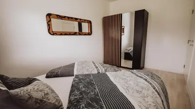 a bedroom with a bed with a mirror on the wall at Villa Eden Bihać in Bihać