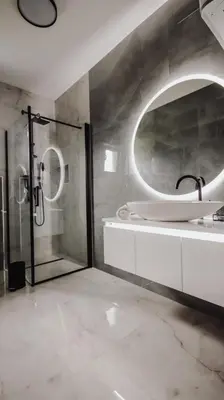 a bathroom with a shower and a sink and a mirror at Villa Eden Bihać in Bihać