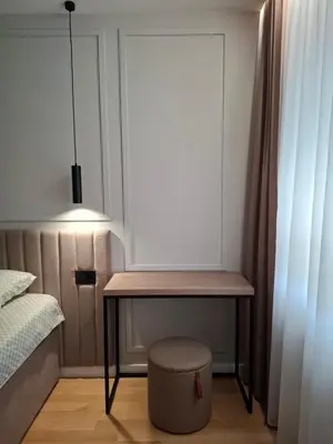 a bedroom with a table next to a bed at Sparkle Home in Banja Luka