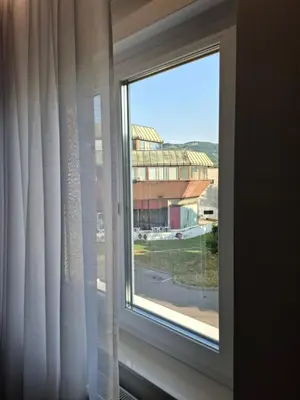a window with a view of a building at Sparkle Home in Banja Luka