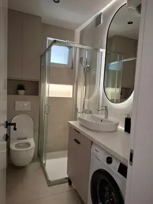 a bathroom with a toilet and a sink and a mirror at Sparkle Home in Banja Luka