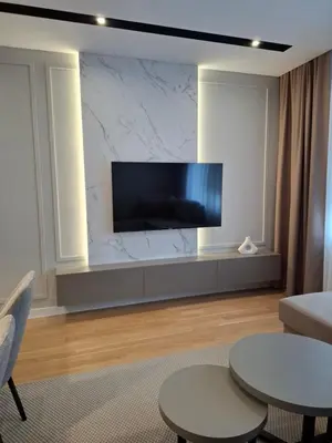 a living room with a flat screen tv on a wall at Sparkle Home in Banja Luka