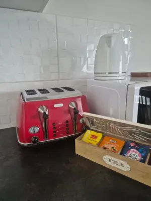 a red toaster sitting on top of a kitchen counter at Apartman Srbac in Srbac