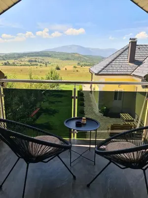 a patio with two chairs and a table on a balcony at Dora in Livno