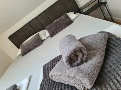 a bed with two towels on top of it at Dora in Livno