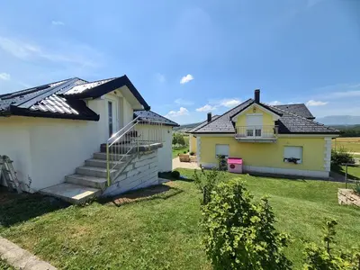 a house with a staircase next to a yard at Dora in Livno