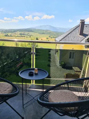 a patio with two chairs and a table on a balcony at Dora in Livno