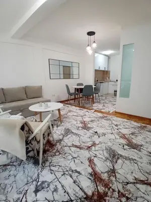 a living room with a couch and a table at AS Emporio Omega 2 in Tuzla