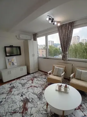 a living room with a couch and a table at AS Emporio Omega 2 in Tuzla