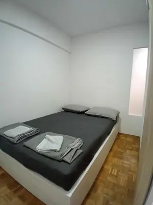 a bed in a room with a mirror at AS Emporio Omega 2 in Tuzla