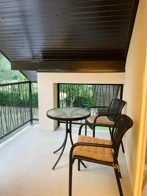 a patio with a table and two chairs on a balcony at Hacienda DM in Visoko